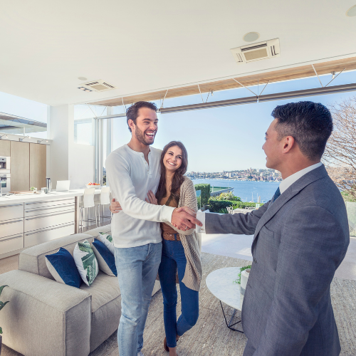 Real estate agent working on a laptop, potentially using the Compass CRM platform.