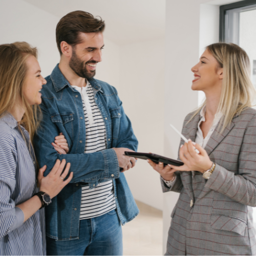 Real estate agent working with clients, supported by one of the top 10 real estate CRM platforms.